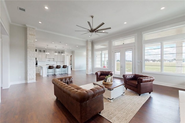 living room featuring ceiling fan, ornamental molding, dark wood-type flooring, and french doors