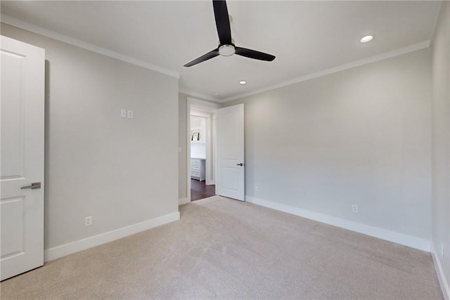 carpeted empty room with ceiling fan and crown molding