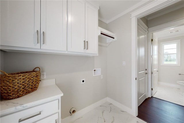 clothes washing area with cabinets, electric dryer hookup, crown molding, hookup for a washing machine, and light wood-type flooring