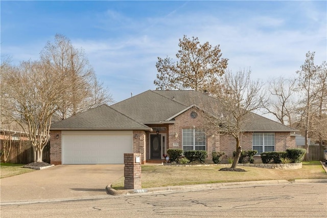 view of front of house featuring brick siding, a shingled roof, concrete driveway, fence, and a garage