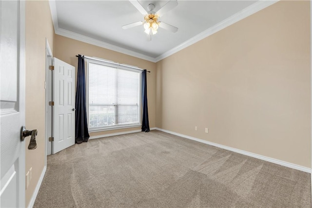 empty room with light colored carpet, crown molding, and baseboards