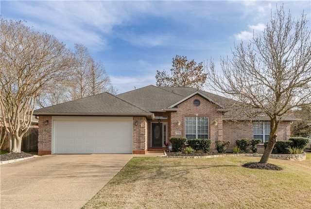 single story home featuring driveway, roof with shingles, an attached garage, a front yard, and brick siding