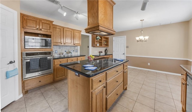 kitchen with light tile patterned floors, stainless steel appliances, a center island, brown cabinets, and tasteful backsplash