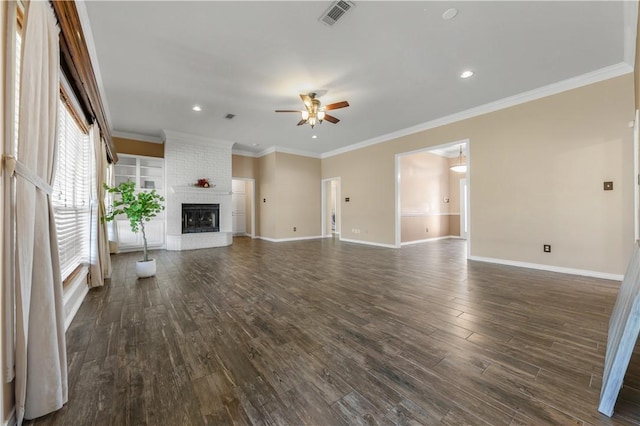 unfurnished living room featuring dark wood-style floors, a fireplace, crown molding, visible vents, and baseboards