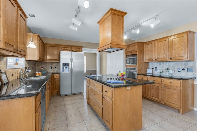 kitchen with dark stone countertops, a center island, decorative light fixtures, black appliances, and a sink