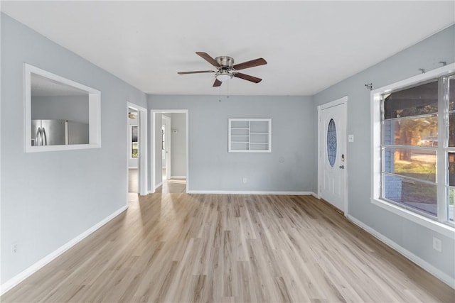 unfurnished living room with ceiling fan and light hardwood / wood-style floors