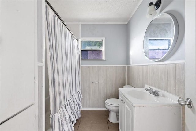 bathroom featuring vanity, tile patterned flooring, toilet, and a textured ceiling