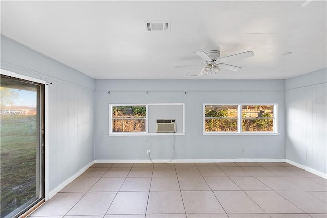 tiled empty room with cooling unit and ceiling fan