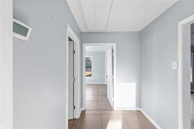 hall featuring light tile patterned floors