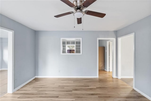 spare room featuring ceiling fan and light hardwood / wood-style flooring