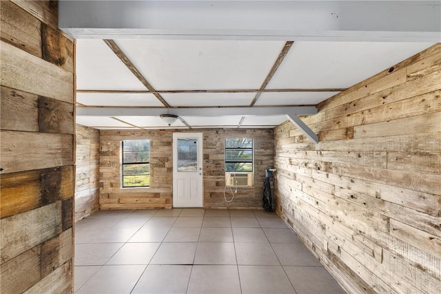 interior space with light tile patterned flooring, wooden walls, cooling unit, and a wealth of natural light