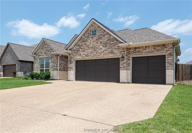 3549 Foxcroft Path, Bryan, TX 77808 - view of front of property with an attached garage, brick siding, concrete driveway, and roof with shingles