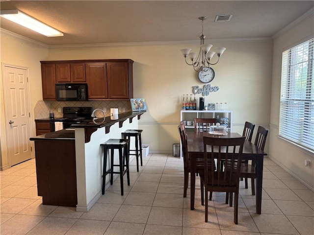 152 Forest Dr, College Station, TX 77840 - dining space featuring a chandelier, healthy amount of natural light, light tile patterned flooring, and ornamental molding