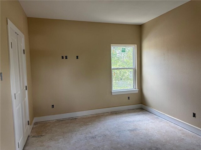 807 S Coulter Dr, Bryan, TX 77803 - empty room with baseboards and concrete floors