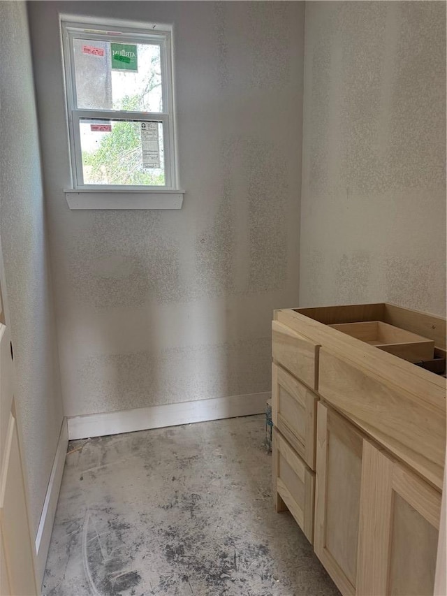807 S Coulter Dr, Bryan, TX 77803 - bathroom featuring unfinished concrete floors, vanity, and a textured wall