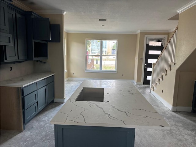 807 S Coulter Dr, Bryan, TX 77803 - kitchen featuring ornamental molding, a kitchen island, and light stone counters