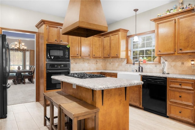 1713 Cardinal Ln, College Station, TX 77845 - kitchen with black appliances, a chandelier, custom exhaust hood, a kitchen island, and hanging light fixtures