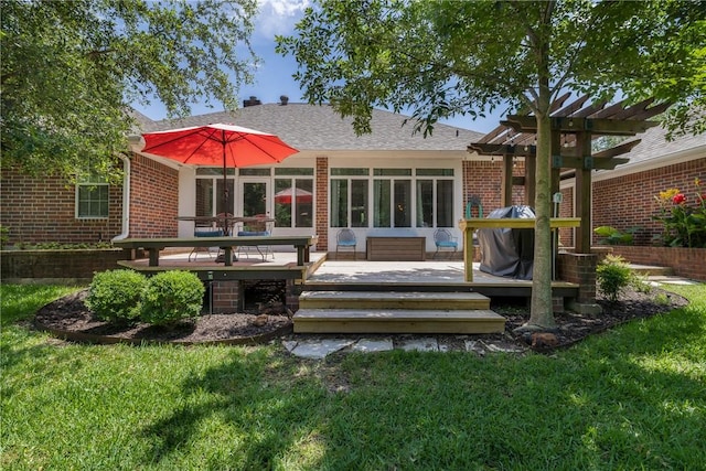 1713 Cardinal Ln, College Station, TX 77845 - rear view of property featuring a wooden deck, brick siding, a lawn, and a shingled roof