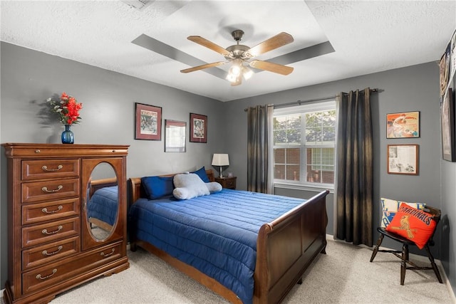 1713 Cardinal Ln, College Station, TX 77845 - bedroom with light colored carpet, a textured ceiling, a ceiling fan, and baseboards