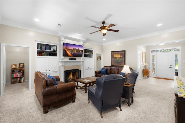 1713 Cardinal Ln, College Station, TX 77845 - living area with ceiling fan, crown molding, light colored carpet, a warm lit fireplace, and recessed lighting