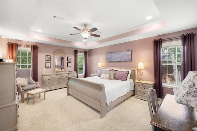 1713 Cardinal Ln, College Station, TX 77845 - bedroom featuring a raised ceiling, light carpet, and a ceiling fan