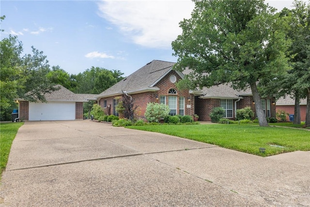 1713 Cardinal Ln, College Station, TX 77845 - view of front of house featuring brick siding, a garage, a front lawn, concrete driveway, and a shingled roof