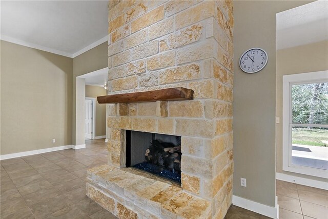 interior details featuring a fireplace, baseboards, and ornamental molding