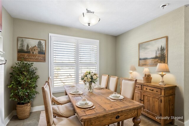 dining area featuring baseboards