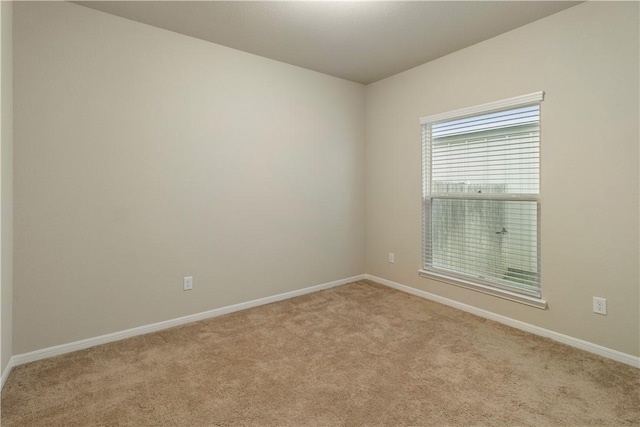 spare room with carpet flooring and baseboards