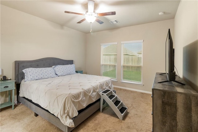 carpeted bedroom featuring visible vents, baseboards, and a ceiling fan