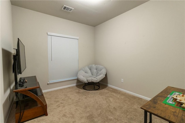 sitting room with baseboards, visible vents, and carpet floors