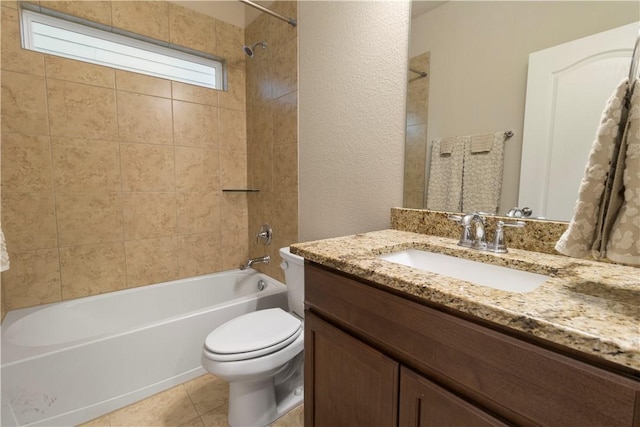 bathroom with tile patterned floors, toilet,  shower combination, and vanity