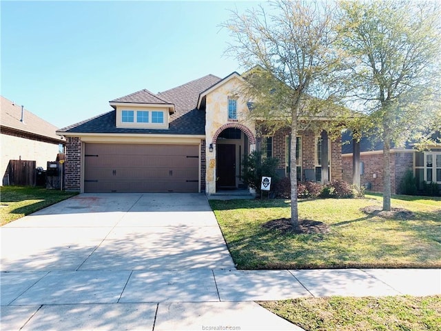 15313 Lowry Meadow Ln, College Station, TX 77845 - traditional home featuring a garage, a front yard, concrete driveway, brick siding, and a shingled roof
