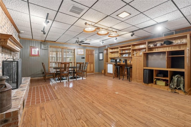 2355 Jackson League Cir, Brenham, TX 77337 - dining room with light wood finished floors, a brick fireplace, a ceiling fan, rail lighting, and baseboards