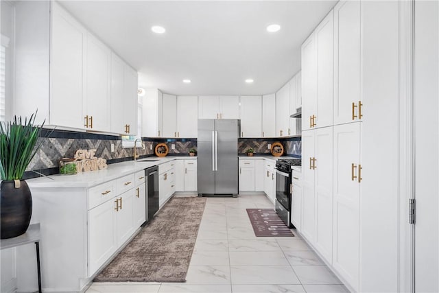3004 Woodville Rd, Bryan, TX 77803 - kitchen featuring appliances with stainless steel finishes, a sink, light marble finish floors, tasteful backsplash, and white cabinetry