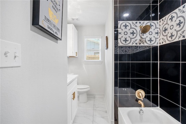 3004 Woodville Rd, Bryan, TX 77803 - bathroom featuring marble look tile flooring, vanity, toilet, and baseboards