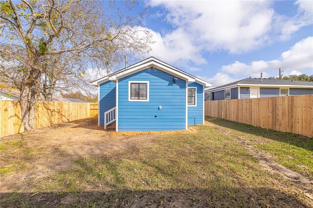 rear view of house with a yard