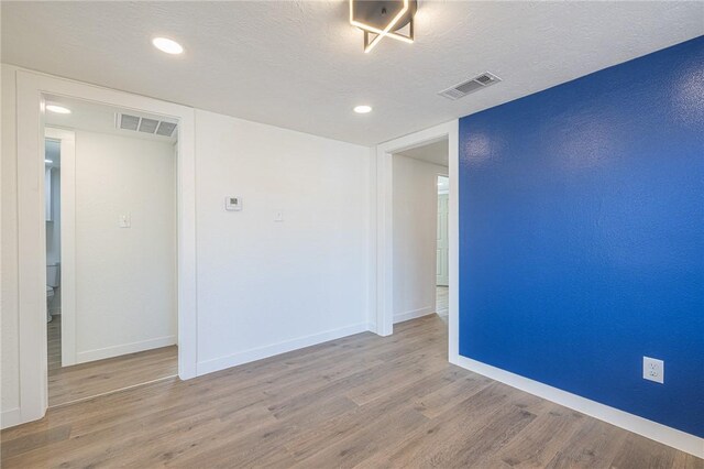 empty room featuring hardwood / wood-style floors and a textured ceiling