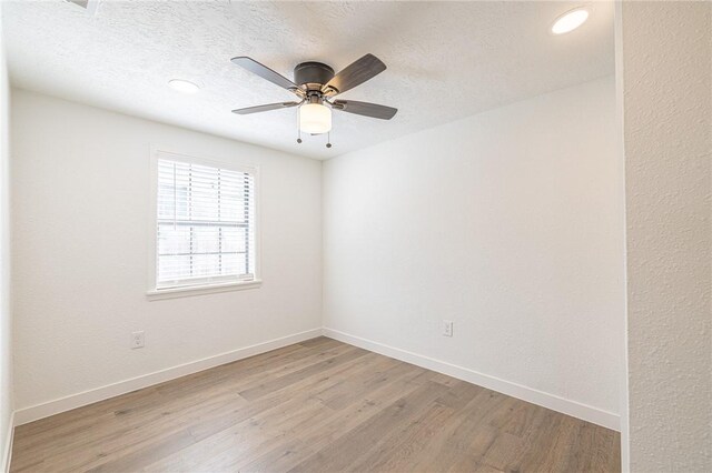 unfurnished room featuring a textured ceiling, light wood-type flooring, and ceiling fan