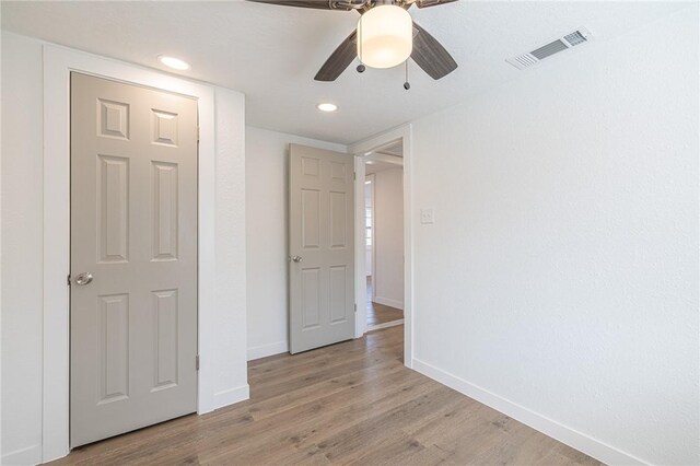 unfurnished bedroom with light wood-type flooring and ceiling fan