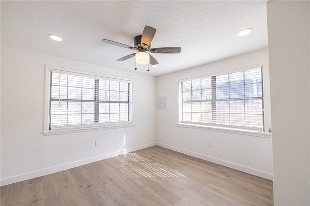 empty room featuring ceiling fan and light wood-type flooring