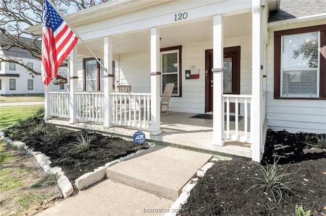 view of exterior entry with a porch