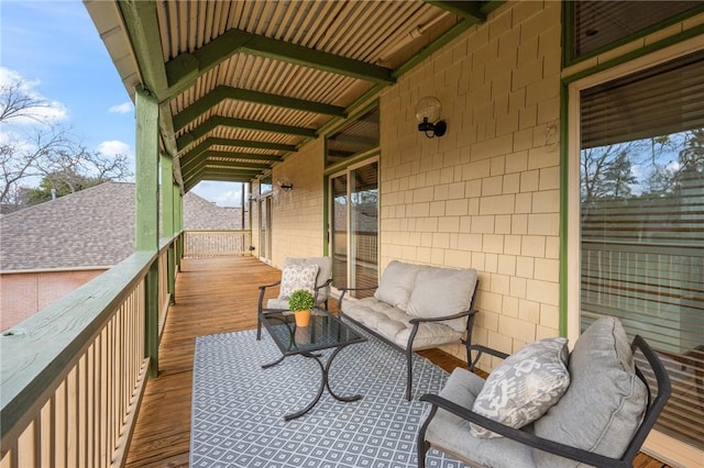 wooden balcony featuring a wooden deck and an outdoor hangout area