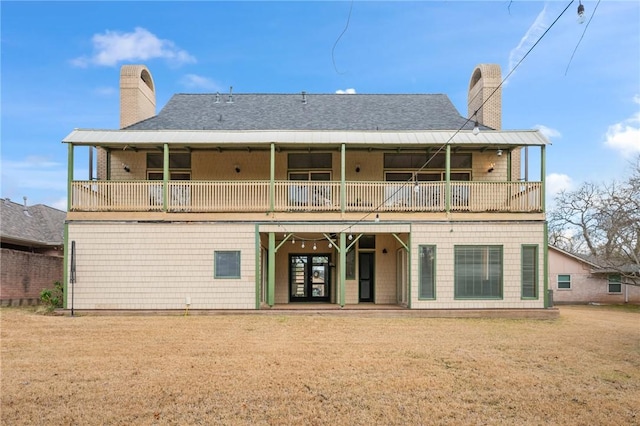 rear view of property featuring a yard