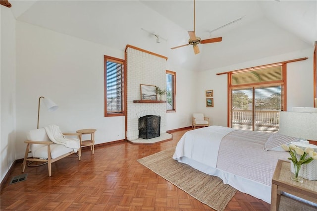 bedroom with ceiling fan, a fireplace, high vaulted ceiling, and light parquet flooring