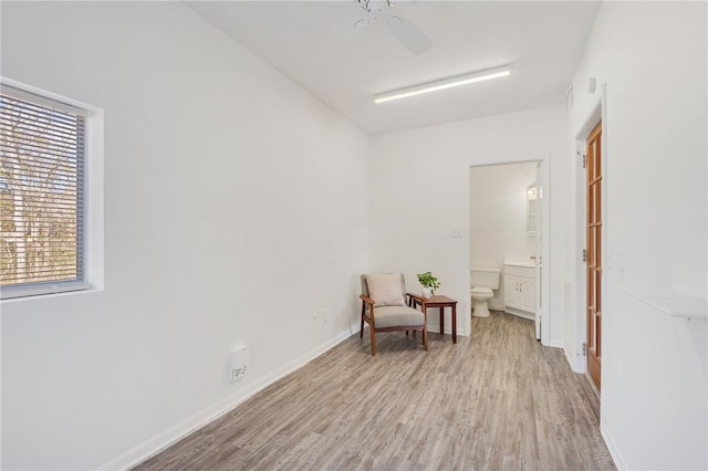 living area with ceiling fan and light hardwood / wood-style floors