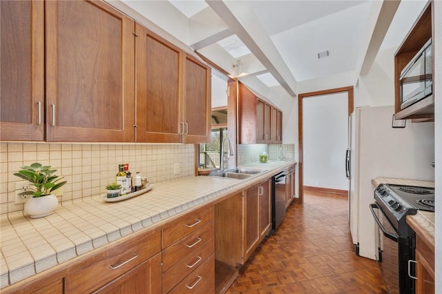 kitchen with black electric range oven, sink, tile countertops, dishwasher, and dark parquet floors