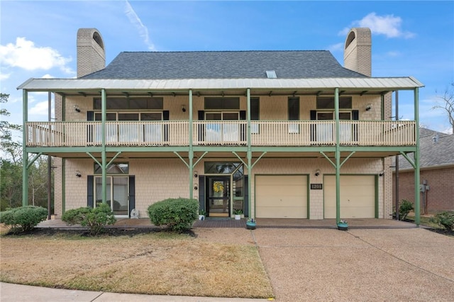 view of front of property with a garage and a balcony