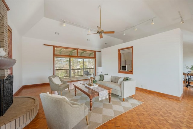 living room with light parquet flooring, high vaulted ceiling, ceiling fan, and a fireplace