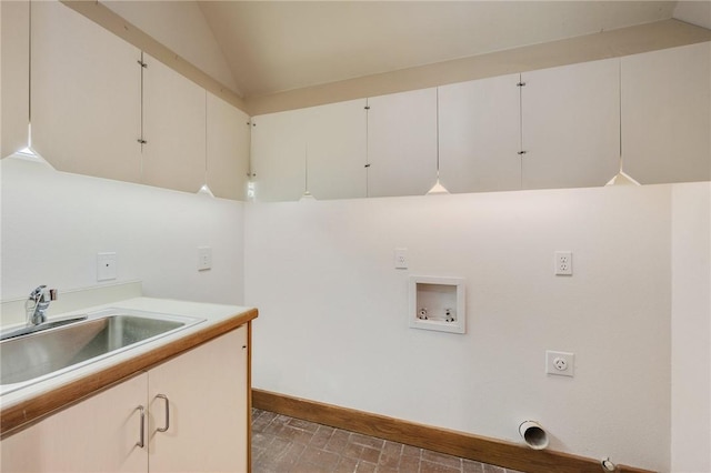 clothes washing area featuring hookup for a washing machine, sink, hookup for an electric dryer, and cabinets